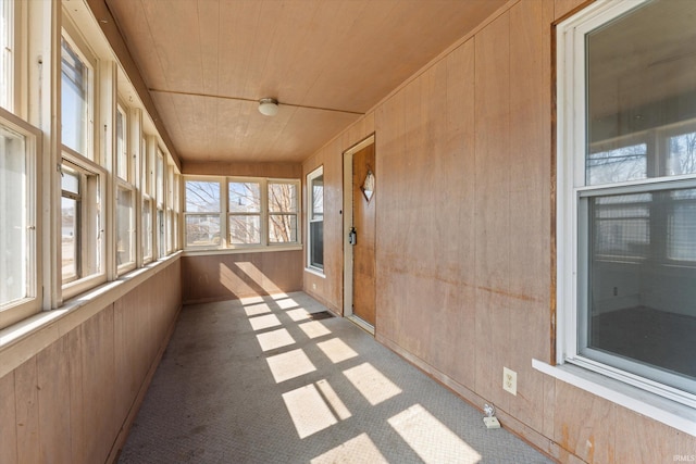 unfurnished sunroom featuring wood ceiling