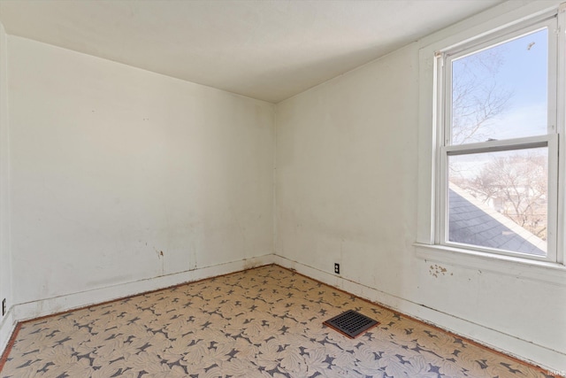 unfurnished room with visible vents and a healthy amount of sunlight