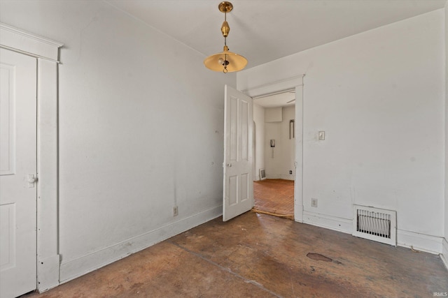 empty room featuring visible vents, concrete floors, and baseboards