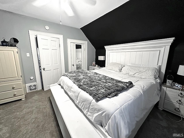 carpeted bedroom with ceiling fan and vaulted ceiling