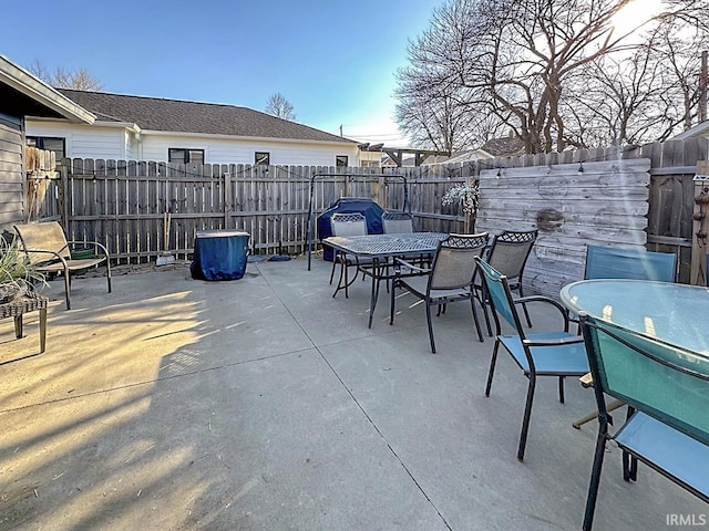 view of patio with outdoor dining area and a fenced backyard