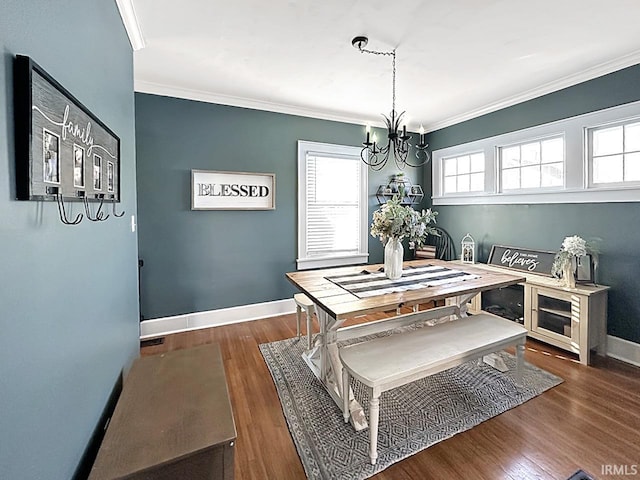 dining area featuring baseboards, wood finished floors, an inviting chandelier, and ornamental molding