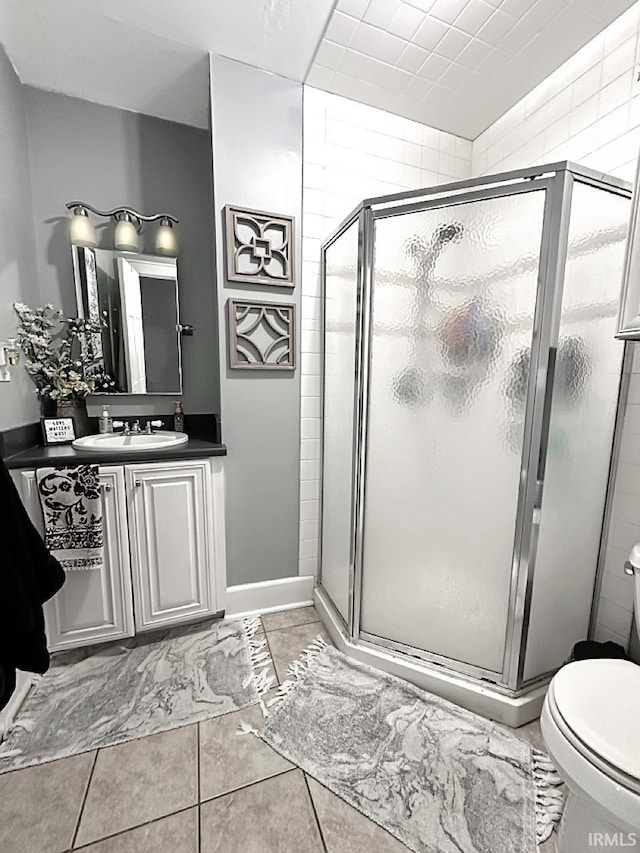 bathroom with vanity, a shower stall, and toilet