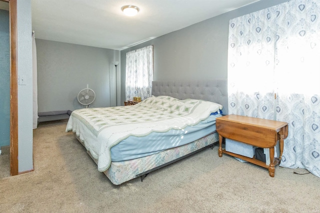 bedroom featuring carpet and baseboards