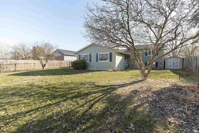 view of yard with an outbuilding, a storage unit, and a fenced backyard