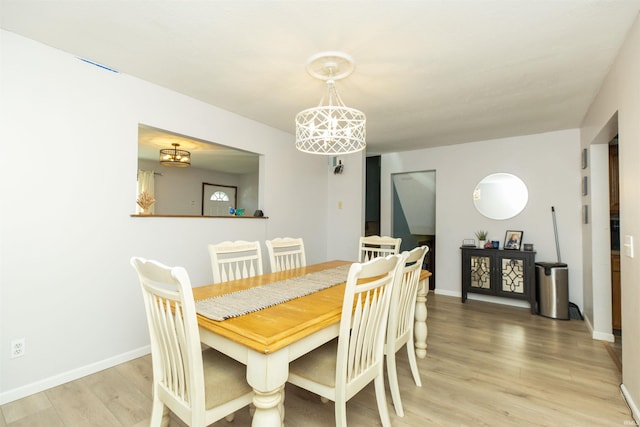 dining room featuring light wood-type flooring and baseboards