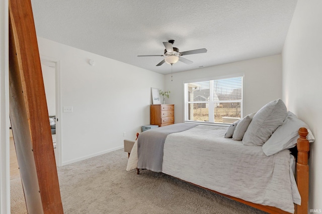 bedroom with carpet flooring, ceiling fan, a textured ceiling, and baseboards