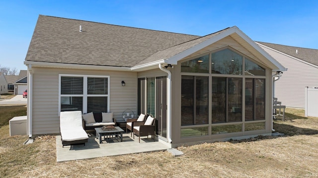 rear view of property with outdoor lounge area, a patio area, a sunroom, and a shingled roof