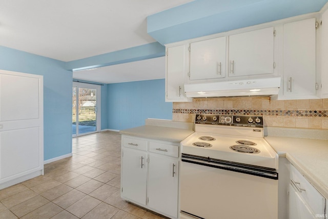 kitchen with under cabinet range hood, tasteful backsplash, electric stove, and light countertops