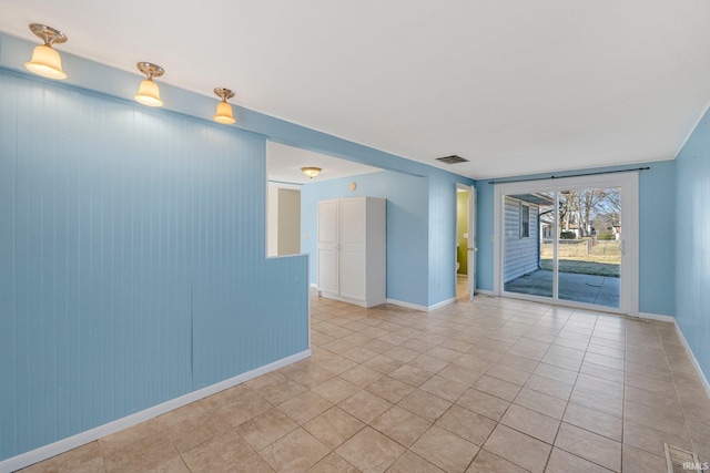 spare room with light tile patterned floors, visible vents, and baseboards