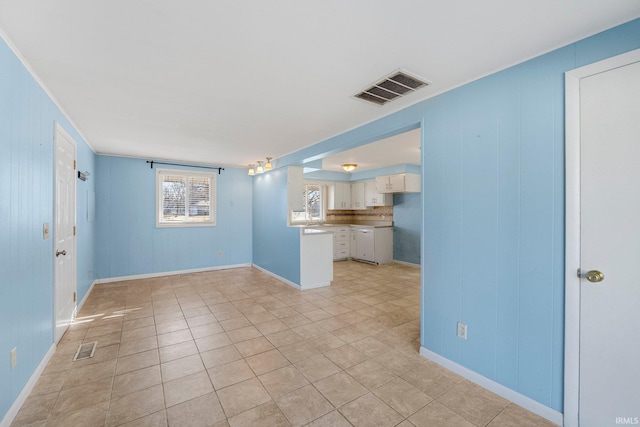 unfurnished living room featuring light tile patterned floors, visible vents, and baseboards