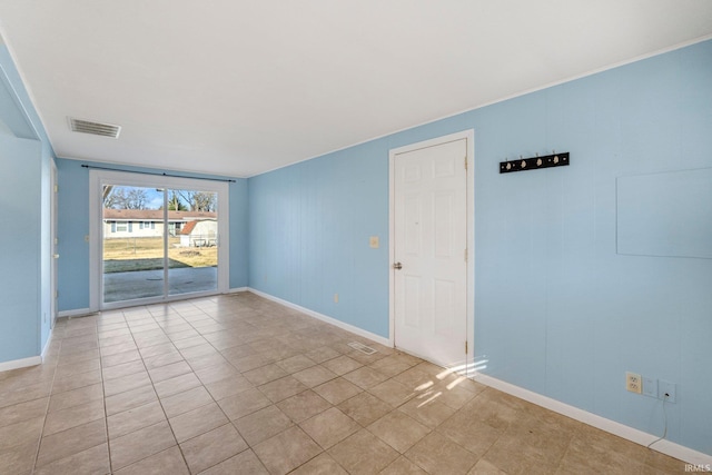 unfurnished room featuring visible vents and baseboards