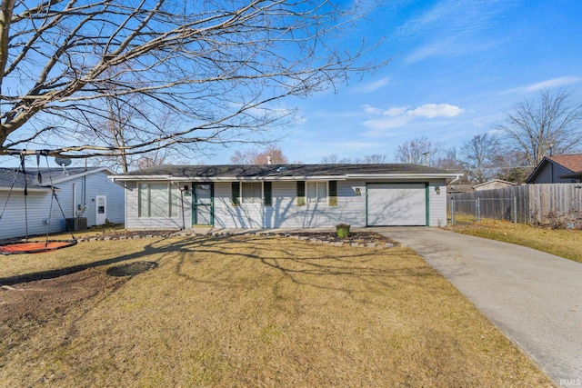 view of front of house with fence, a chimney, concrete driveway, a front lawn, and a garage