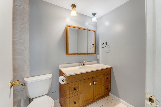 bathroom with vanity, toilet, baseboards, and tile patterned flooring