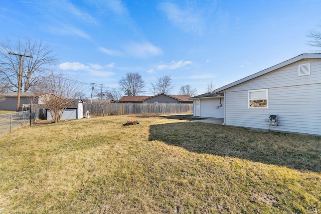 view of yard featuring an outdoor structure and a fenced backyard