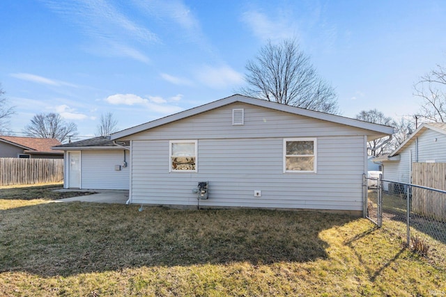 rear view of house featuring a yard and fence private yard