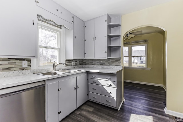 kitchen with dishwasher, open shelves, plenty of natural light, and a sink