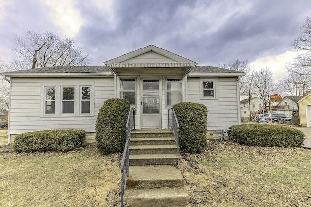 bungalow featuring a shingled roof