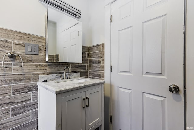 bathroom with tile walls and vanity