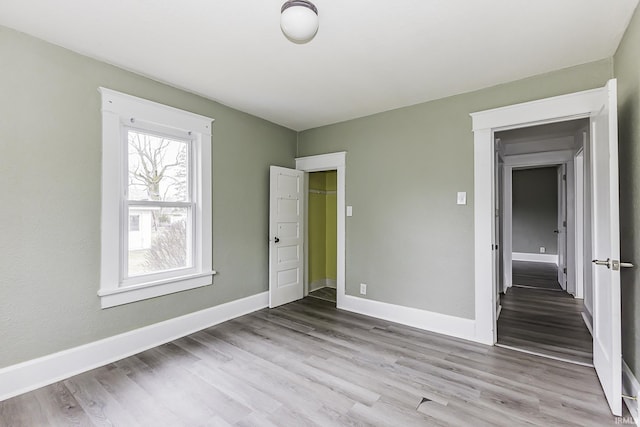 unfurnished bedroom featuring baseboards and wood finished floors