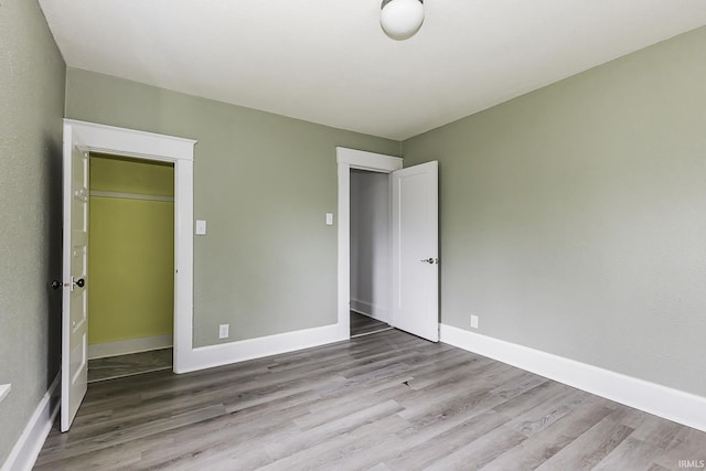 unfurnished bedroom featuring baseboards and wood finished floors