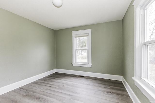 unfurnished room featuring baseboards and wood finished floors