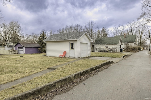 exterior space featuring an outbuilding and driveway