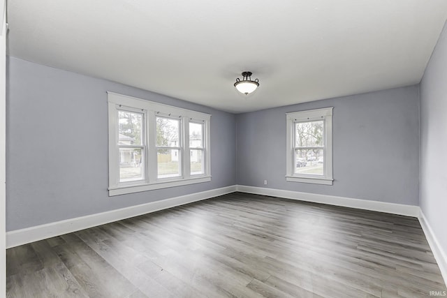 unfurnished room featuring wood finished floors and baseboards