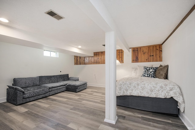 bedroom with light wood-type flooring, visible vents, baseboards, and recessed lighting