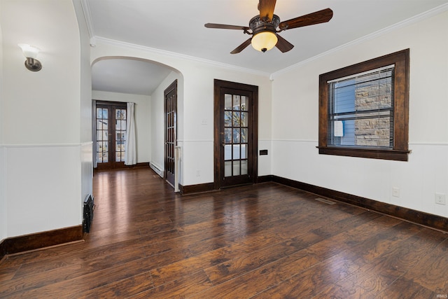 unfurnished room featuring wood finished floors, french doors, arched walkways, and a healthy amount of sunlight