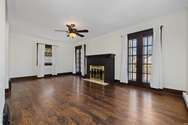 unfurnished living room with a wealth of natural light, french doors, wood finished floors, and ceiling fan