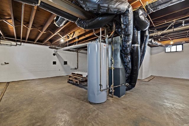 basement featuring gas water heater and concrete block wall