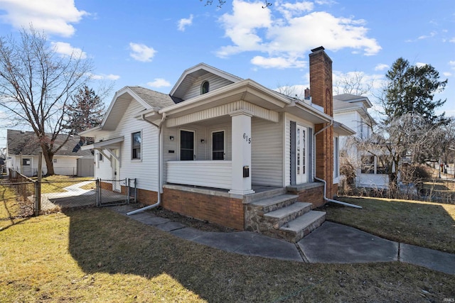 bungalow featuring a gate, a porch, fence, a front yard, and a chimney