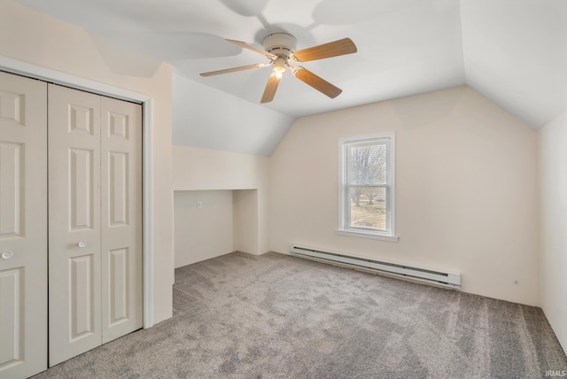 additional living space with ceiling fan, vaulted ceiling, carpet flooring, and a baseboard radiator