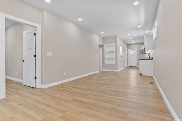 unfurnished living room with recessed lighting, visible vents, baseboards, and light wood-style floors