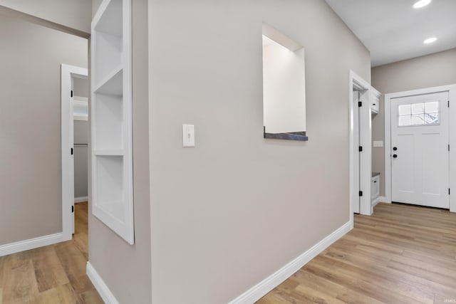 corridor featuring recessed lighting, light wood-style floors, and baseboards