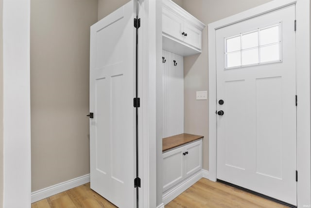 mudroom featuring baseboards and light wood-style floors