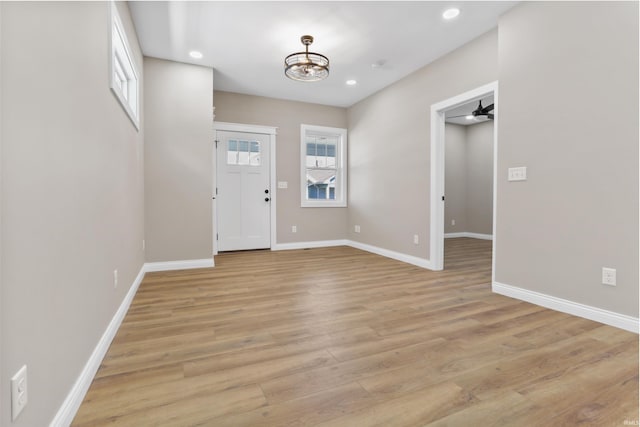 entryway with a notable chandelier, recessed lighting, baseboards, and light wood-style floors