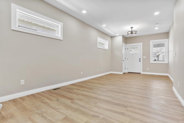 foyer entrance with light wood finished floors, visible vents, recessed lighting, and baseboards