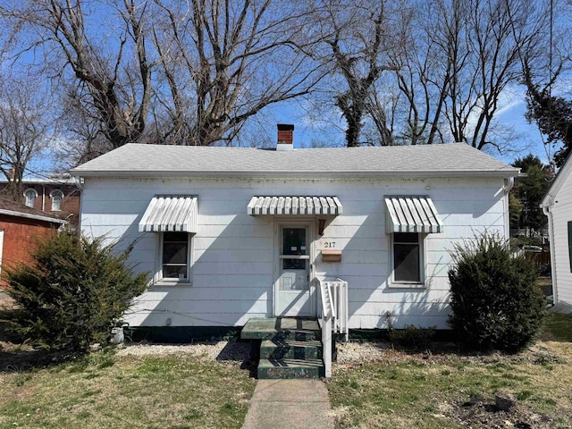 bungalow-style home with a chimney