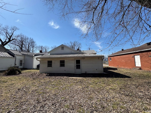 back of property featuring roof with shingles