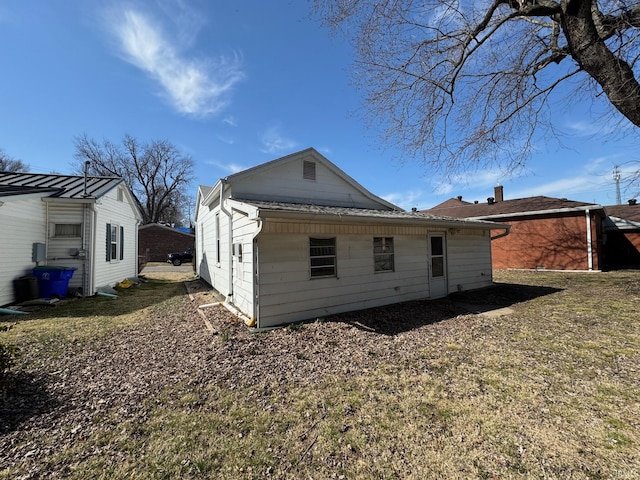 back of property featuring a shingled roof