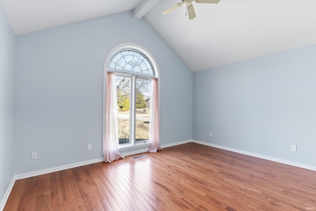 unfurnished room with baseboards, visible vents, vaulted ceiling with beams, ceiling fan, and wood-type flooring