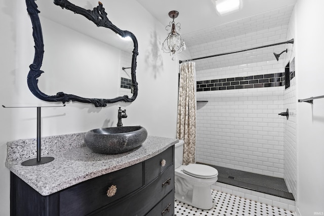 full bath with vanity, toilet, and a shower stall