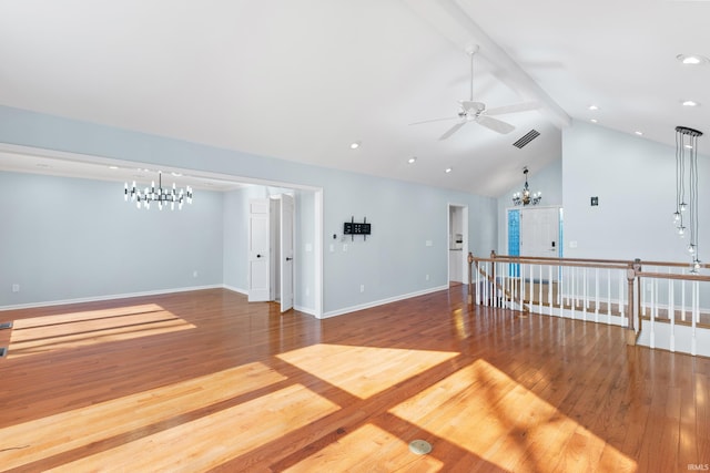 spare room with beam ceiling, visible vents, baseboards, and wood finished floors