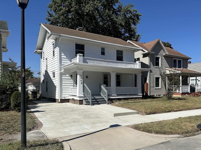 view of front of home featuring a balcony and covered porch