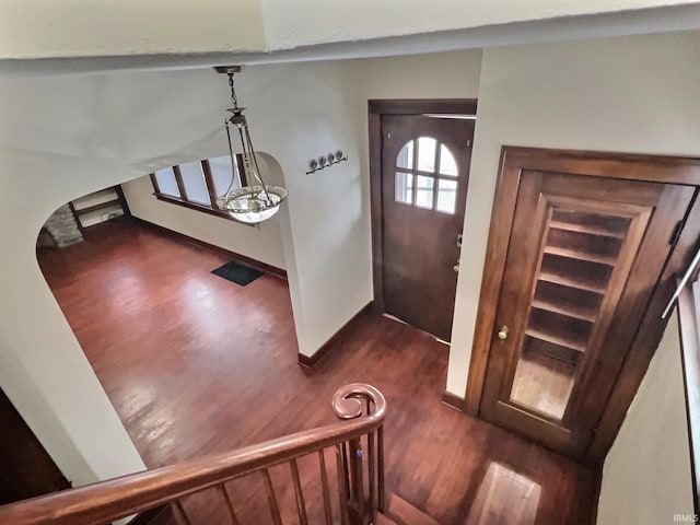 entrance foyer with dark wood finished floors and baseboards