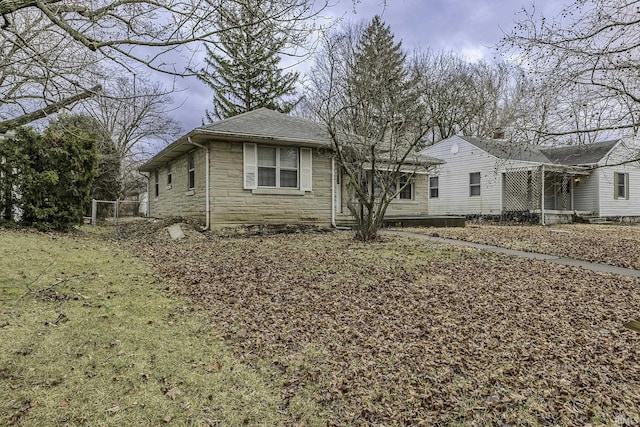 view of front of property with stone siding and roof with shingles