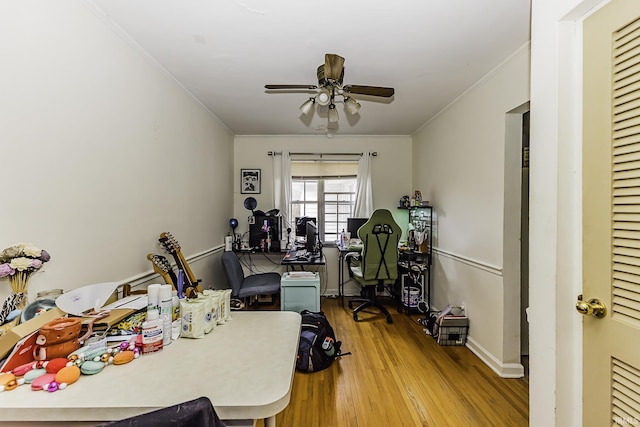 home office featuring baseboards, wood finished floors, ceiling fan, and ornamental molding