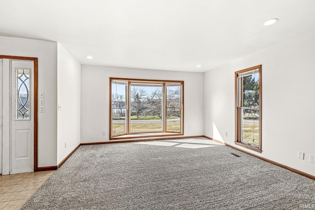 foyer entrance featuring recessed lighting, baseboards, and light colored carpet